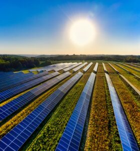 Aerial view of a solar farm in Red Wing, MN, with solar panels harnessing the sun's energy.