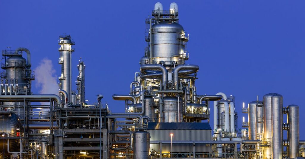 A modern industrial refinery structure under a clear twilight sky in Zuid-Holland, Netherlands.